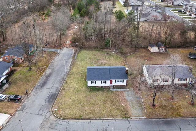 an aerial view of a house with a yard