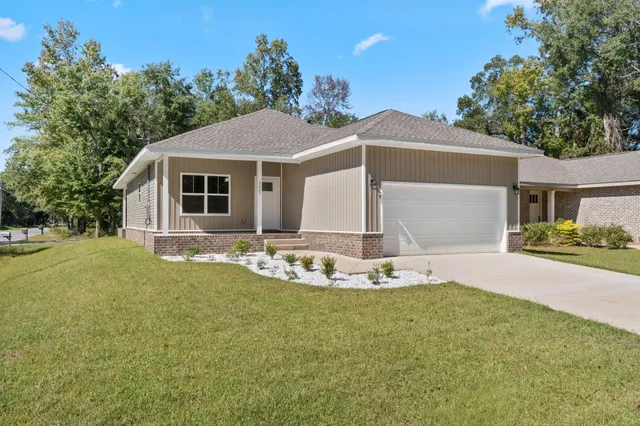 a front view of a house with a yard and garage