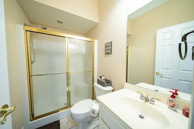 a kitchen with stainless steel appliances kitchen island granite countertop a refrigerator dining table and chairs