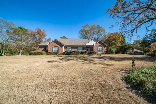 a backyard of a house with lots of green space and trees