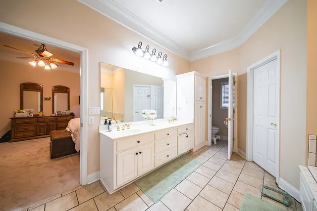 a bedroom with bed and a chandelier