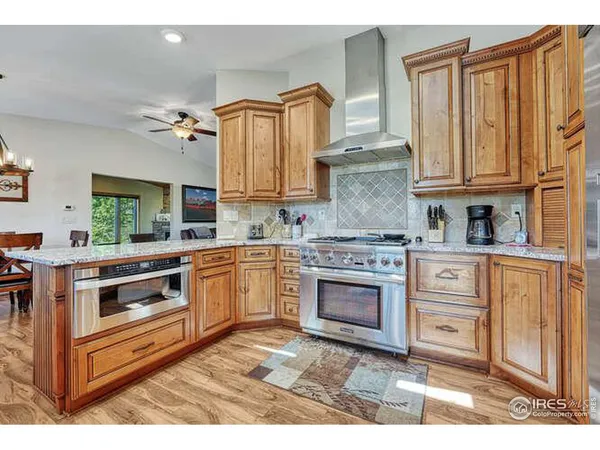 a kitchen with granite countertop a stove and a refrigerator