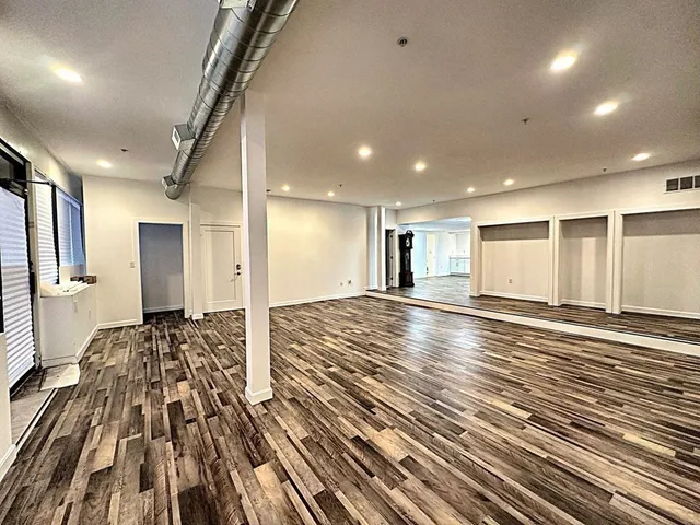 a view of a room with wooden floor