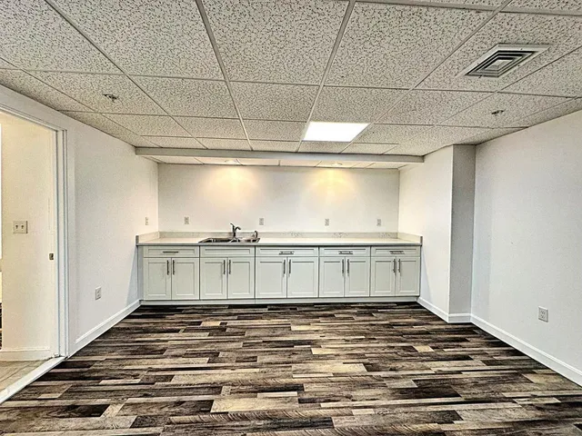 a view of a room with wooden floor