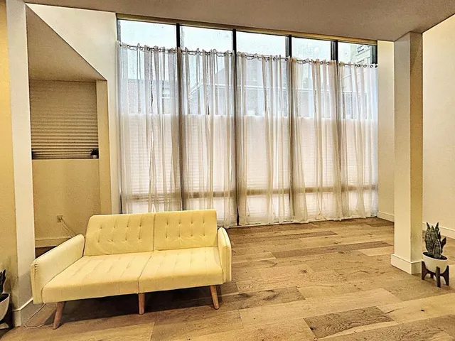 a living room with furniture and large window