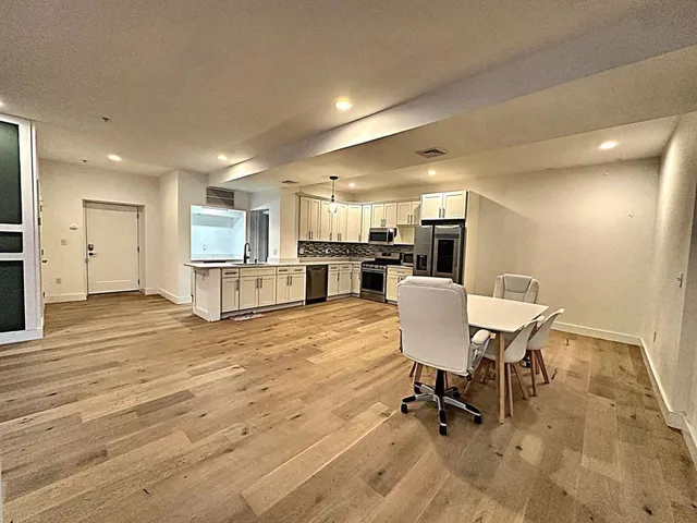 a view of a dining room with furniture and a wooden floor