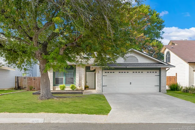a front view of house with a garden