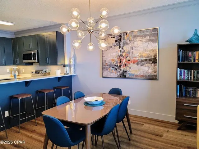 a view of a dining room with furniture and wooden floor
