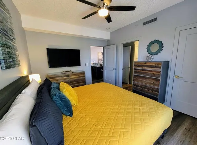 a bed room with a bed and a flat screen tv