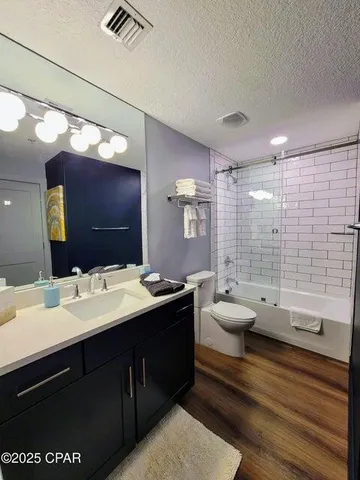 a bathroom with a double vanity sink toilet and shower