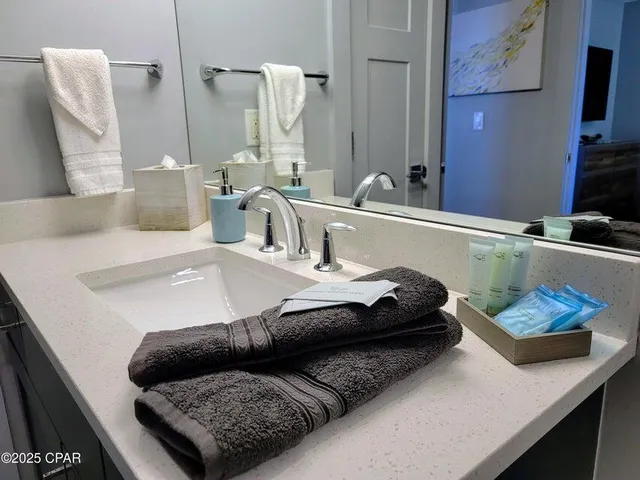 a bathroom with a granite countertop sink and a mirror