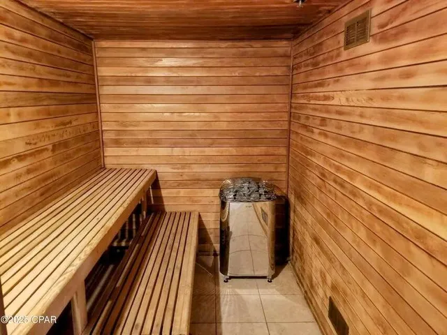 a view of a balcony with wooden floor and a floor to ceiling window
