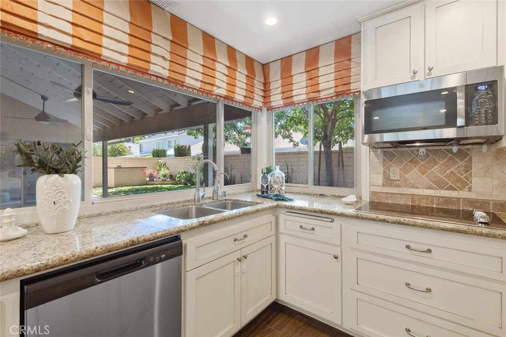 23950 Avenida Crescenta Valencia, CA 91355 - Photo 17 of 44 a kitchen with granite countertop stainless steel appliances a sink and cabinets