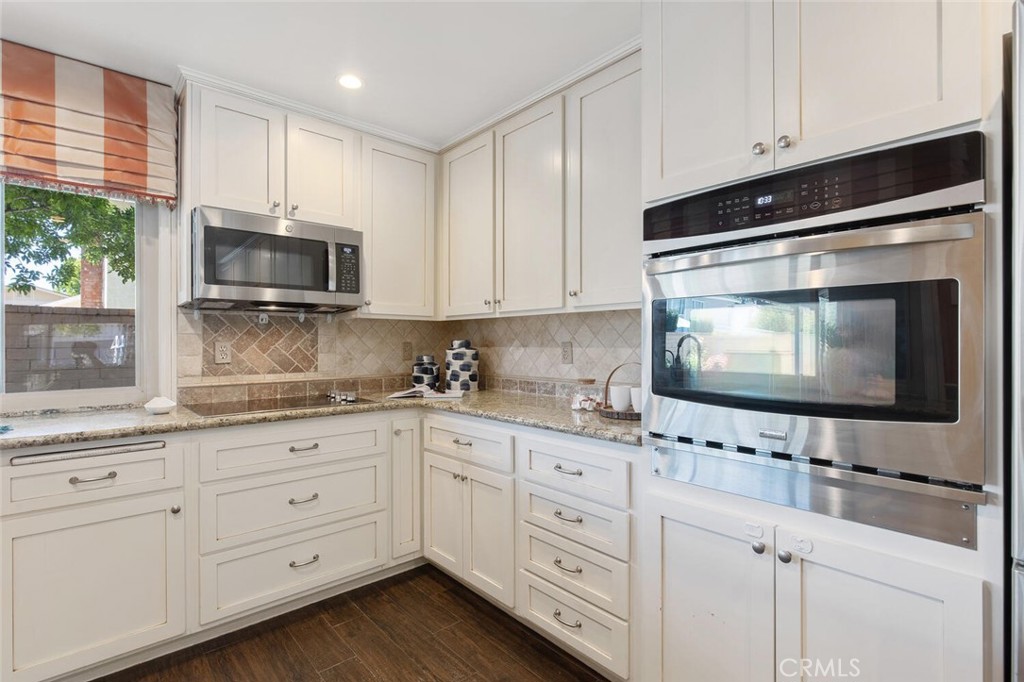 23950 Avenida Crescenta Valencia, CA 91355 - Photo 19 of 44 a kitchen with granite countertop white cabinets and stainless steel appliances