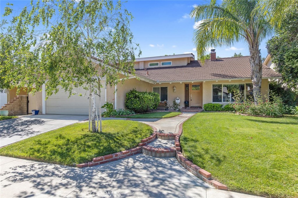 23950 Avenida Crescenta Valencia, CA 91355 - Photo 2 of 44 a front view of a house with garden