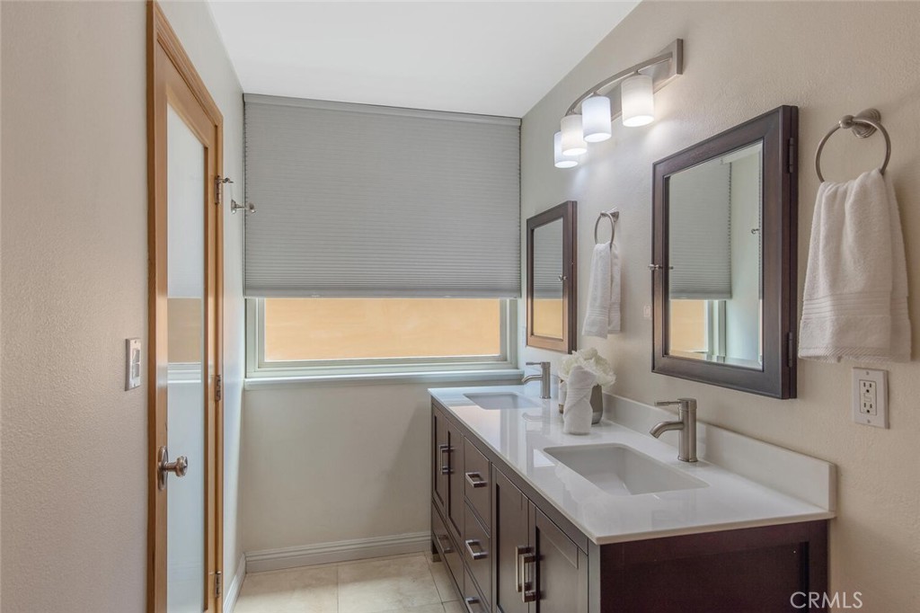 23950 Avenida Crescenta Valencia, CA 91355 - Photo 23 of 44 a bathroom with 2 sink and a mirror