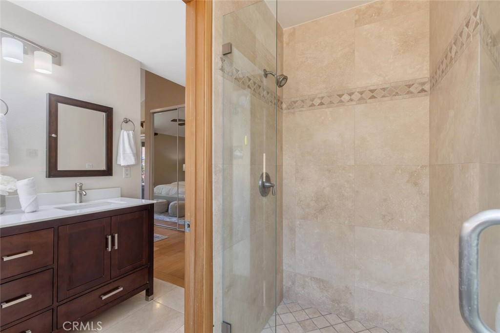 23950 Avenida Crescenta Valencia, CA 91355 - Photo 27 of 44 a bathroom with a double vanity sink toilet mirror and shower