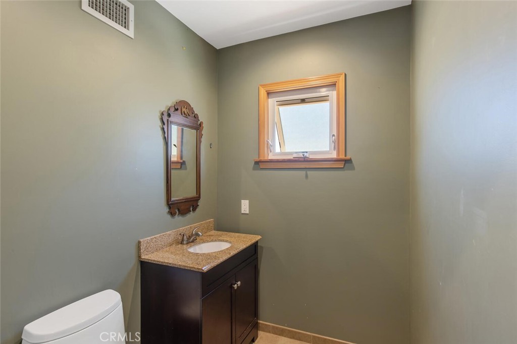 23950 Avenida Crescenta Valencia, CA 91355 - Photo 36 of 44 a bathroom with a sink a toilet and mirror