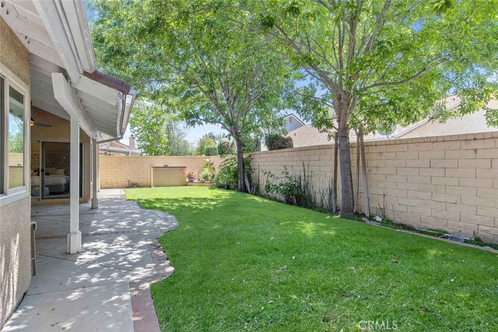 23950 Avenida Crescenta Valencia, CA 91355 - Photo 38 of 44 a view of a backyard with large trees and a barn