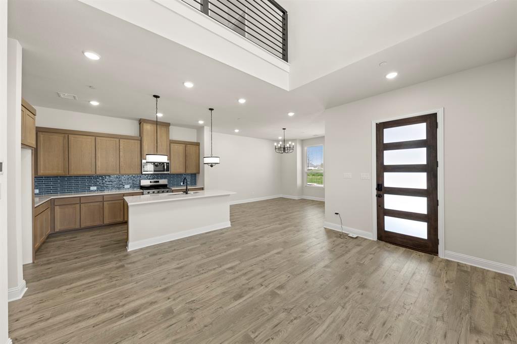 3900 Keya Drive Prosper, TX 75078 - Photo 8 of 36 a view of kitchen with kitchen island white cabinets and stainless steel appliances