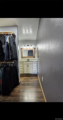 a bathroom with a sink mirror vanity and toilet