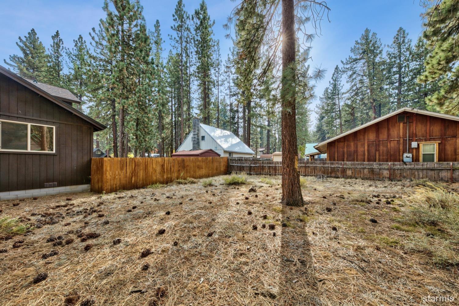 1124 Martin Avenue South Lake Tahoe, CA 96150 - Photo 11 of 16 a backyard of a house with wooden fence and porch