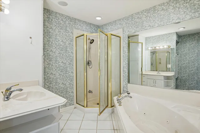 a bathroom with a tub sink and mirror