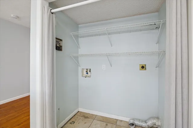 a view of storage and utility room with racks on the wall
