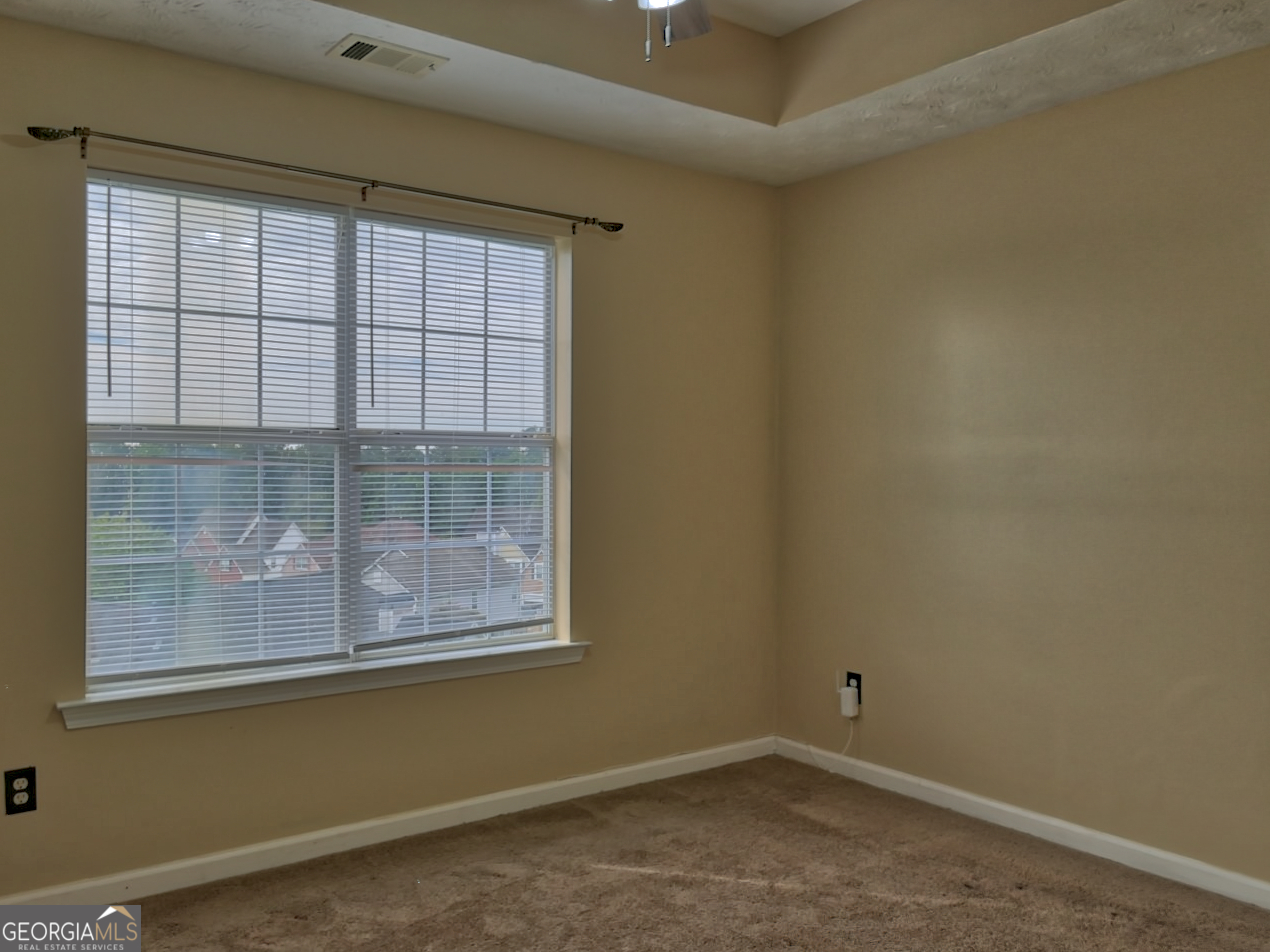 512 Chaucer Way Stockbridge, GA 30281 - Photo 11 of 25 an empty room with a window