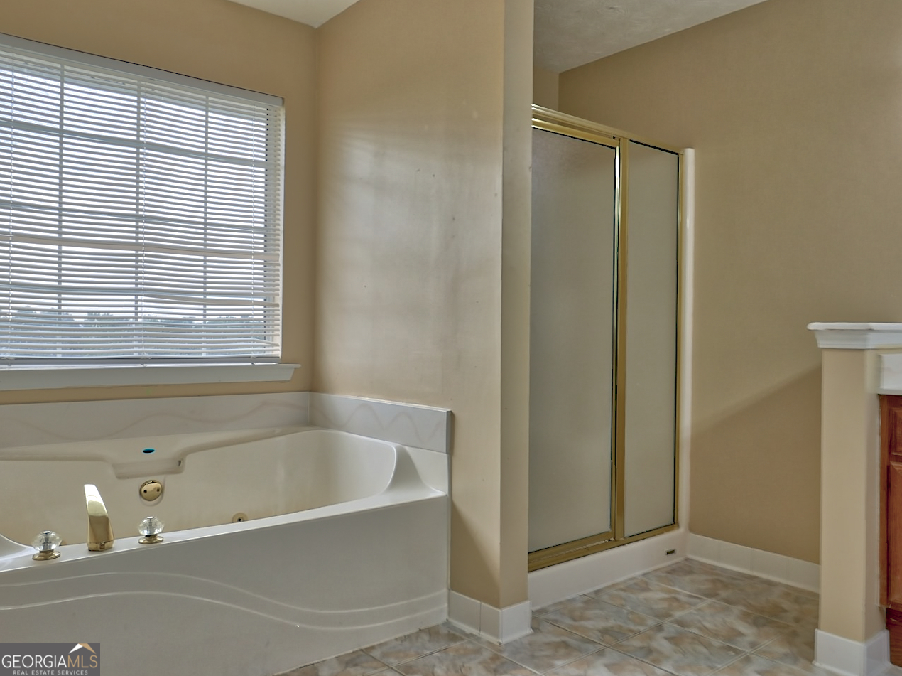 512 Chaucer Way Stockbridge, GA 30281 - Photo 17 of 25 a white bath tub sitting next to a window