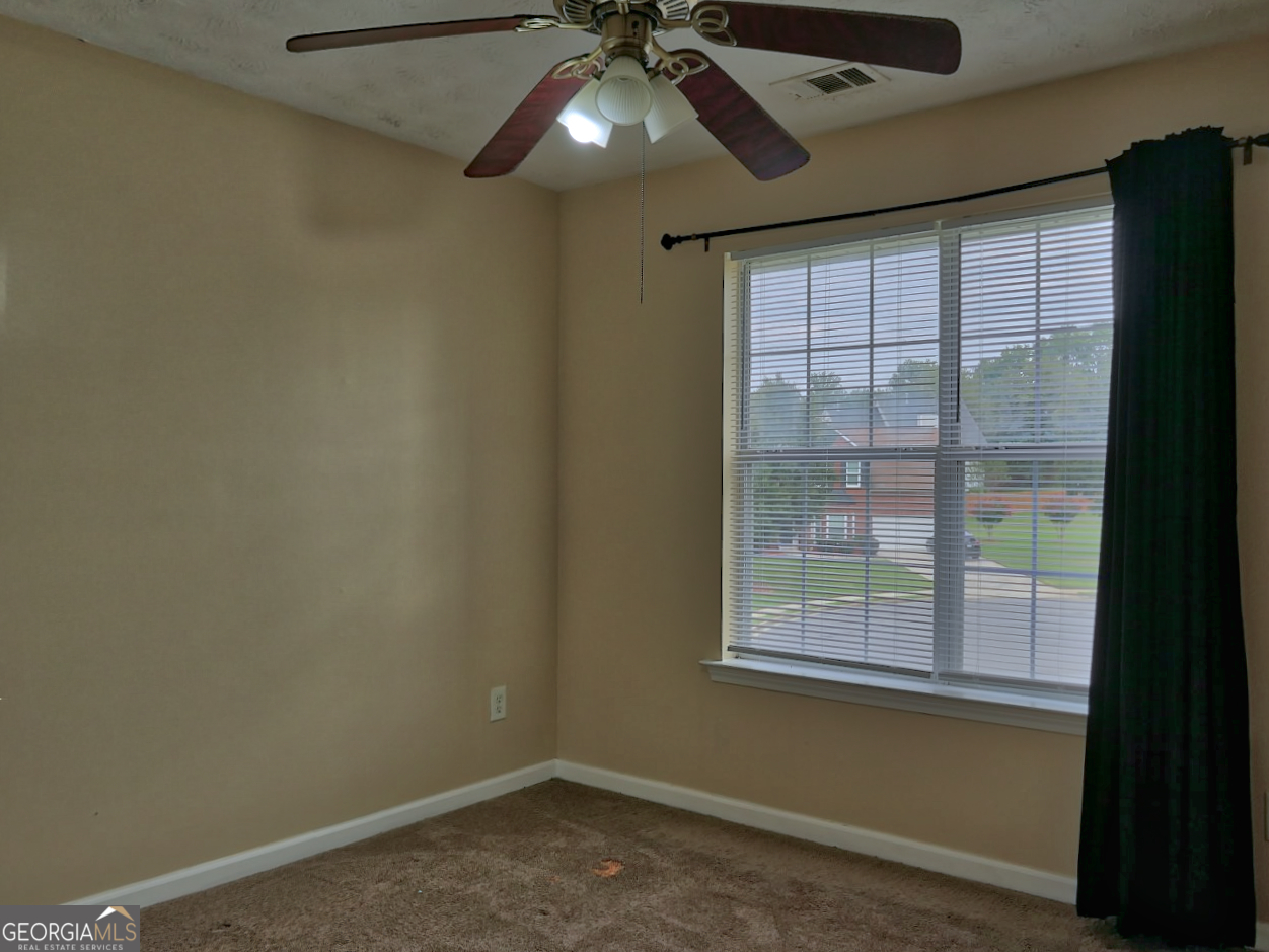 512 Chaucer Way Stockbridge, GA 30281 - Photo 20 of 25 a view of an empty room with a window