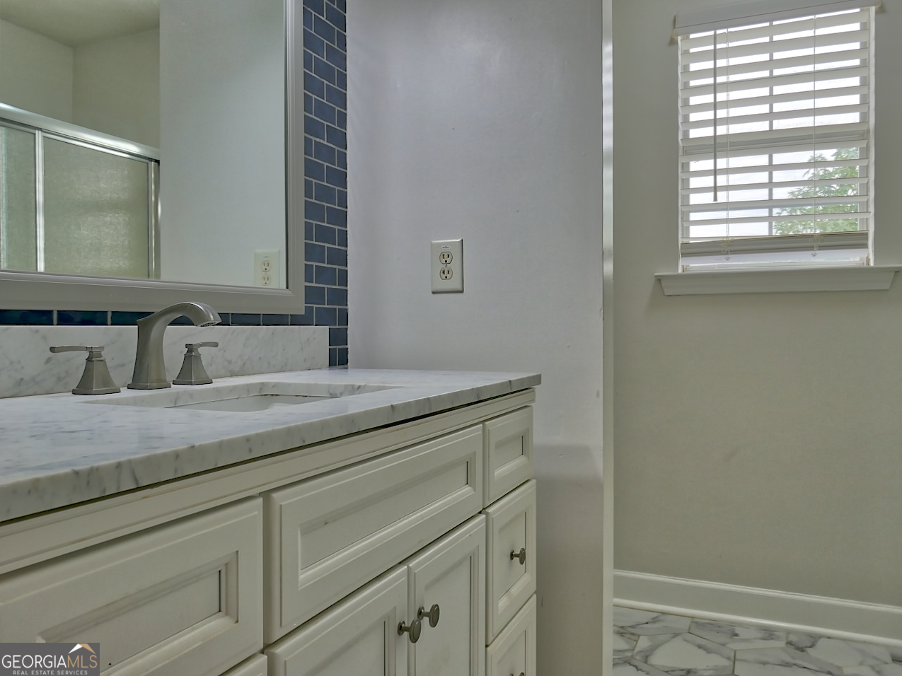 512 Chaucer Way Stockbridge, GA 30281 - Photo 21 of 25 a bathroom with a sink and a mirror