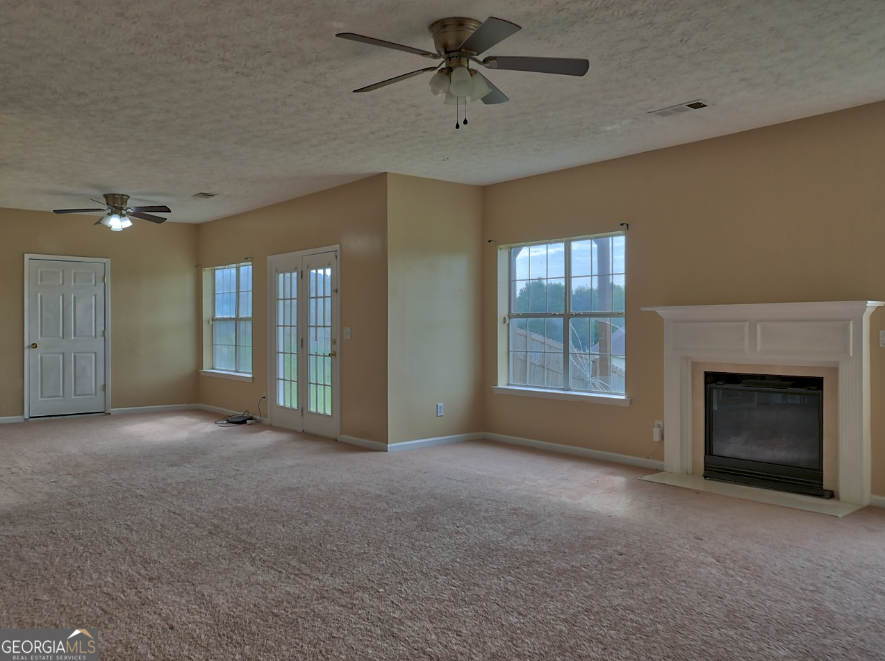 512 Chaucer Way Stockbridge, GA 30281 - Photo 23 of 25 a view of an empty room with a fireplace and a window