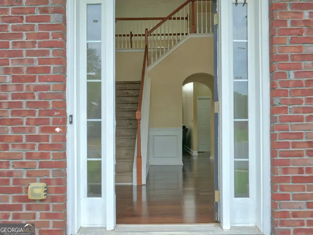 a view of a door with a glass door and shower
