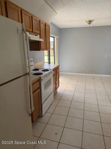 a kitchen with stainless steel appliances a stove a sink and a refrigerator