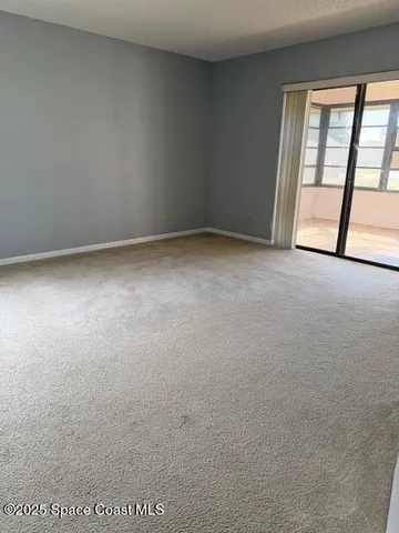 an empty room with a empty space and windows
