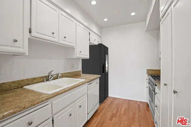 a kitchen with a sink and a refrigerator