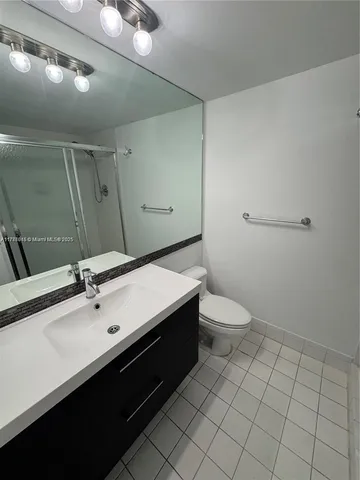 a bathroom with a sink vanity granite and toilet