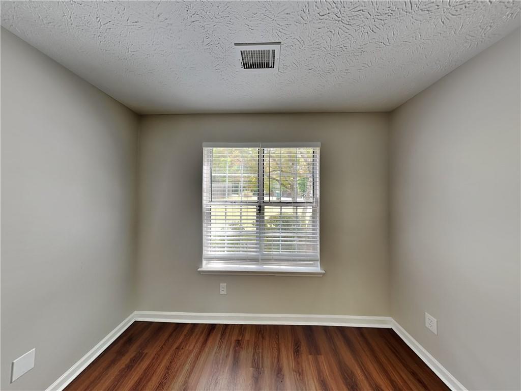3828 Windmill Circle Rex, GA 30273 - Photo 11 of 17 wooden floor in an empty room with a window