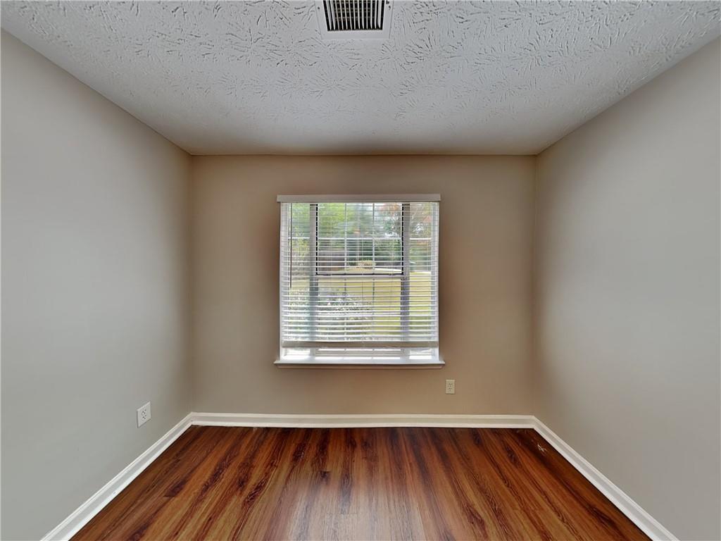 3828 Windmill Circle Rex, GA 30273 - Photo 13 of 17 a view of an empty room with wooden floor and a window
