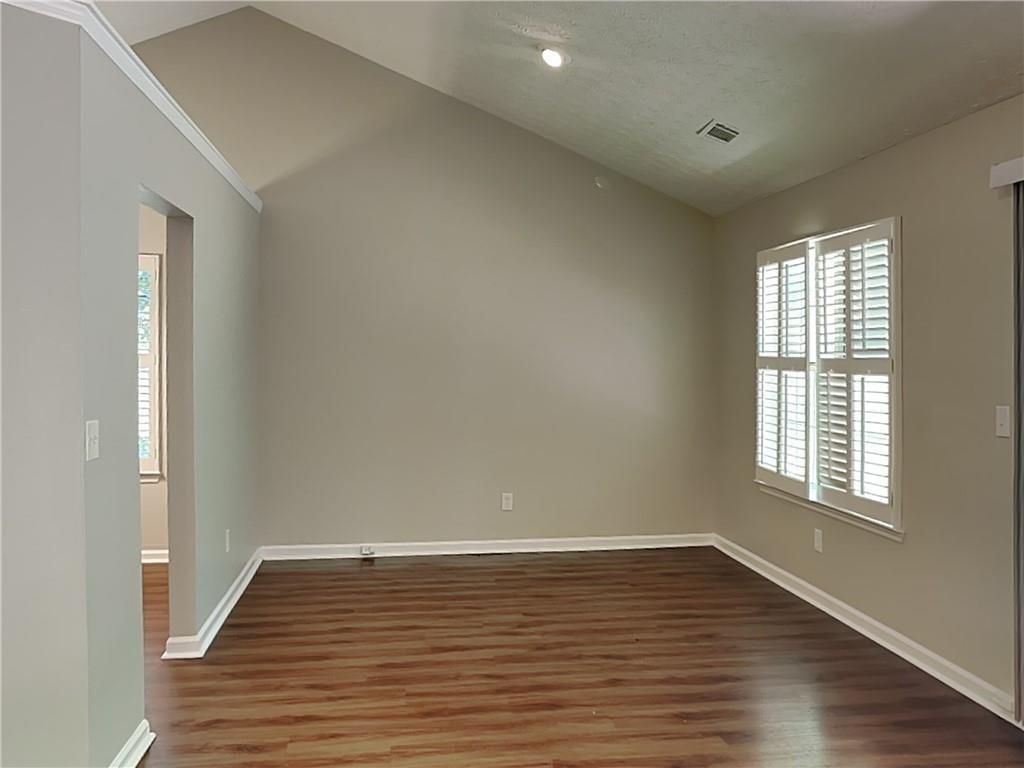 3828 Windmill Circle Rex, GA 30273 - Photo 6 of 17 wooden floor in an empty room with a window
