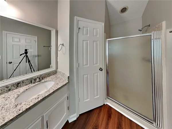 a bathroom with a granite countertop sink mirror and double