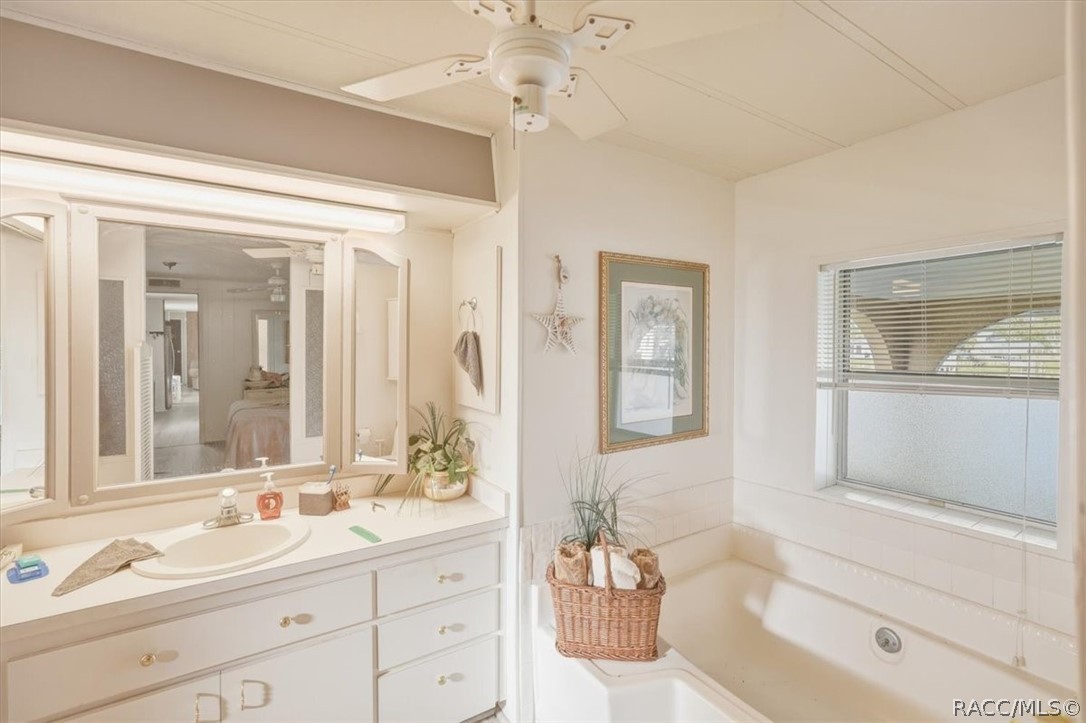 928 South Shad Terrace Inverness, FL 34450 - Photo 19 of 48 a bathroom with a tub sink and mirror