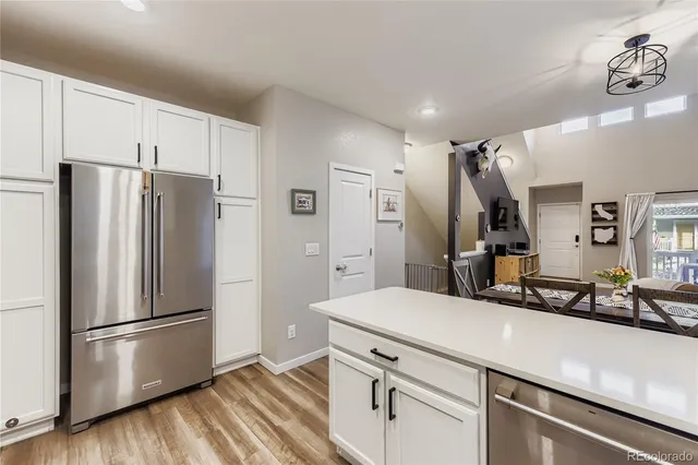 a kitchen with stainless steel appliances a refrigerator and a sink