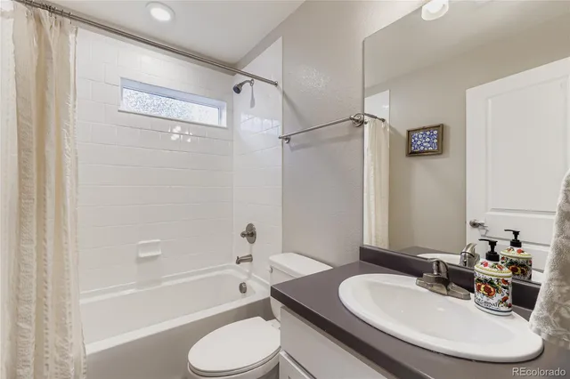 a bathroom with a sink toilet tub and shower