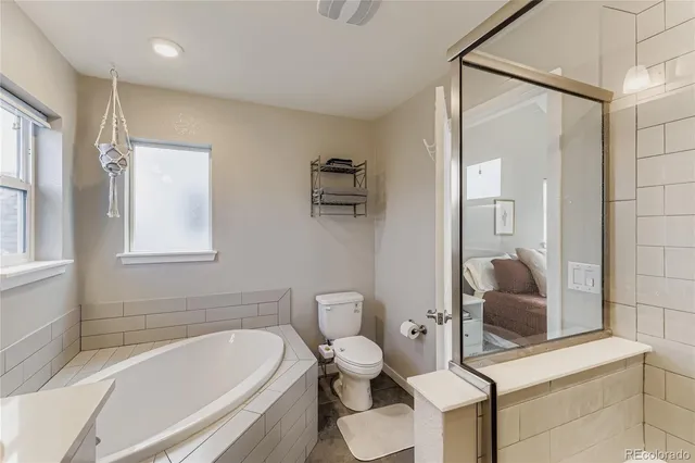 a bathroom with a tub toilet and sink