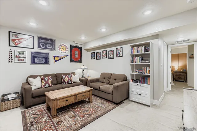 a living room with furniture and painting on the wall