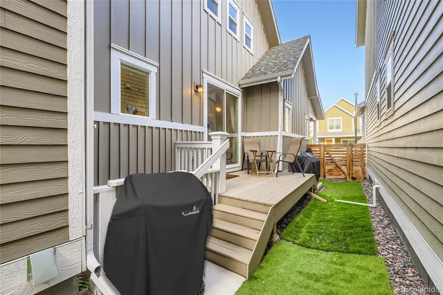 a view of a patio with chair and tables back yard of the house