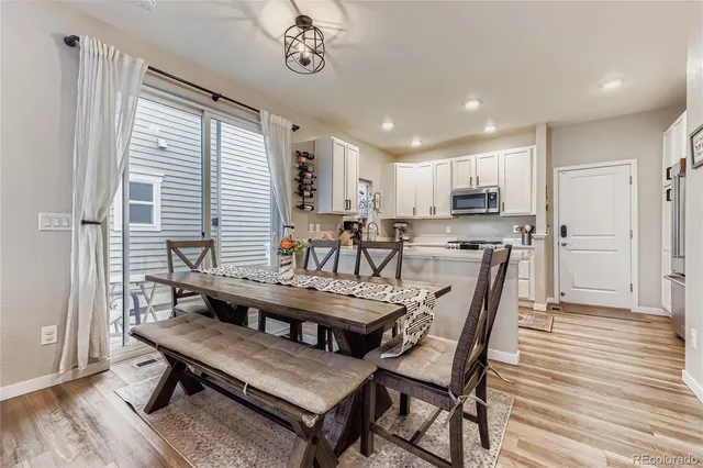 a view of a dining room with furniture window and wooden floor