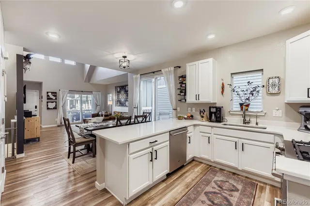 a kitchen with white cabinets and white appliances
